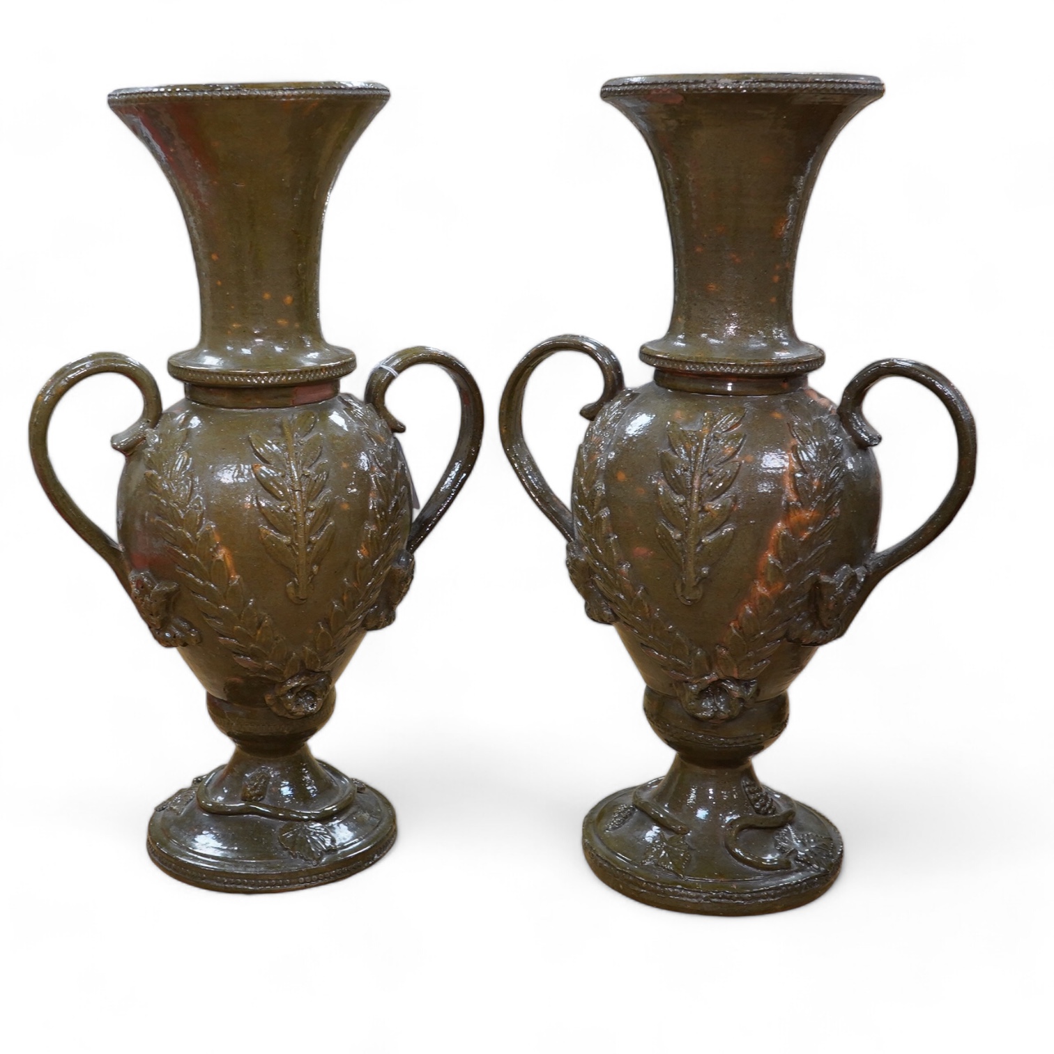 A pair of 19th century continental green glazed two handled pottery vases, 43cm high. Condition - fair